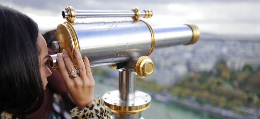 Kayla Heffernan - Banner - Woman looking through Binoculars